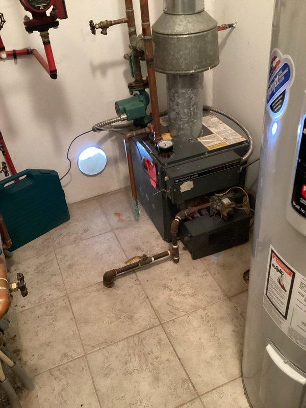 Completed scheduled boiler maintenance service on residential heating system. Inspected aging black boiler unit, associated copper piping, circulation pump, and control components for proper operation. Performed standard preventative maintenance procedures on the heating system to ensure optimal performance for the upcoming season.