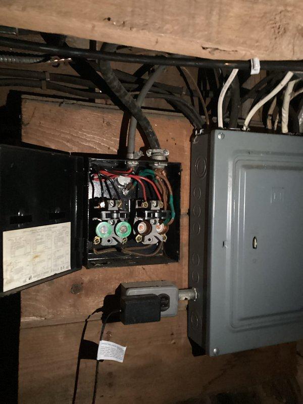 Conducted assessment of heat pump water heater installation requirements between 3-4pm. Evaluated existing electrical infrastructure, including older fuse box and circuit breaker panel, to determine compatibility with new heat pump unit. Photographed current cylindrical water heater with copper pipe connections and documented electrical configuration for proper replacement specifications.