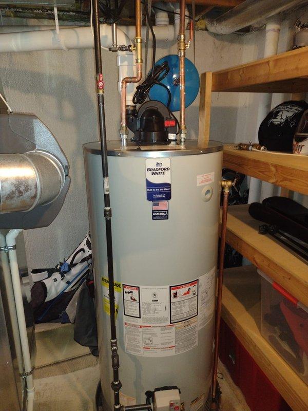 Successfully installed a 75-gallon Bradford White water heater in the utility room, including all necessary copper pipe connections to the existing plumbing system. Installation included mounting a circulation pump assembly and ensuring proper functionality of the complete system.