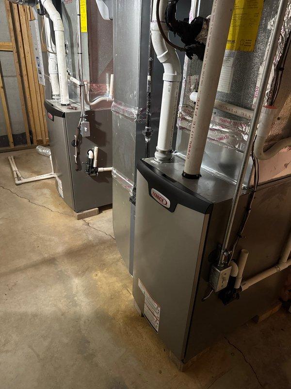 Successfully completed installation of dual Lennox furnaces with S40 thermostats and humidifiers in basement utility area. All units were properly mounted on concrete floor with PVC ventilation pipes correctly routed, and all connections to existing ductwork were secured. System was tested and verified operational with proper documentation completed.