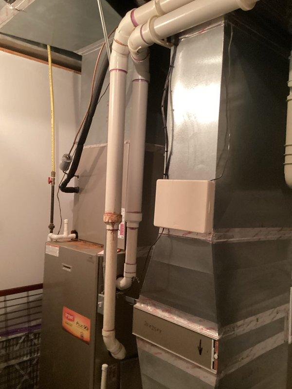 Completed assessment and generated estimate for boiler and furnace replacement. System installation includes primary HVAC unit with properly connected ductwork, sealed metal joints, and PVC condensate drainage/ventilation piping. Complete heating and cooling system features standard components in functional configuration with all necessary electrical connections.