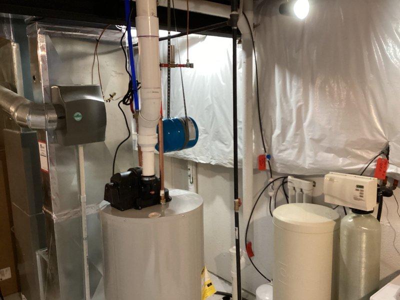 Successfully installed a new 50-gallon water heater in the residential mechanical room, complete with proper PVC connections. System was integrated with existing HVAC and water treatment equipment, ensuring all plumbing connections (including red supply, blue return pipes) were properly sealed and pressure tested.