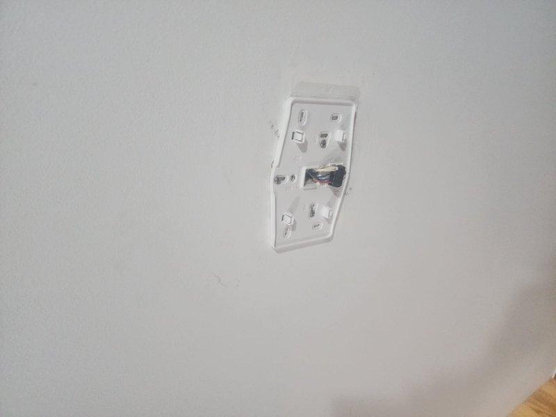 Responded to call back regarding hole in furnace from previous humidifier installation and wall marks near thermostat. Inspected junction box installation and surrounding area, documenting visible wiring and mounting configuration. Noted minor surface marks on interior wall near wooden trim that appeared to be fingerprints as reported by customer.