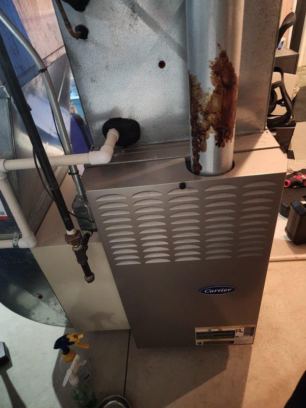 Performed annual heating maintenance on Carrier furnace under Worry Free Service Agreement. Inspected system components, identifying significant corrosion on exhaust piping that requires attention. Completed all standard tune-up procedures and documented condition with photos for service records.