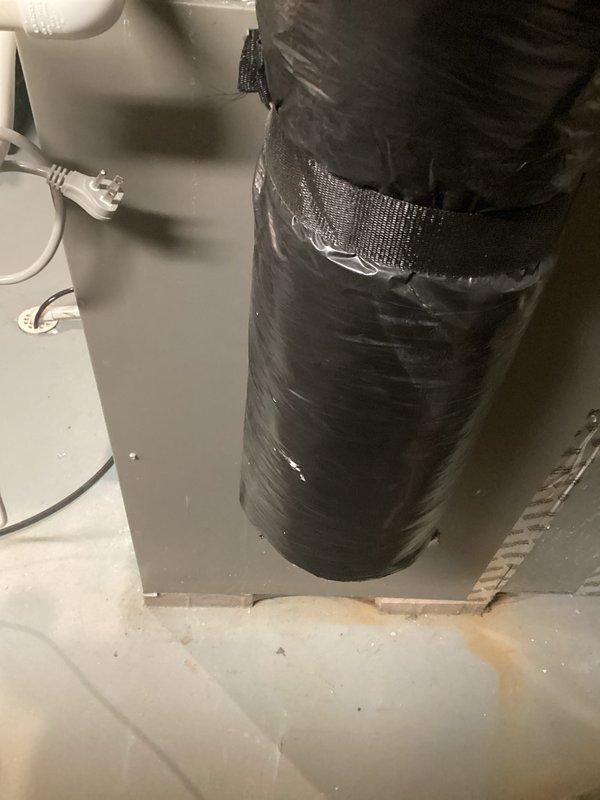 Completed evaluation of 20-year-old furnace (currently operational) with relatively new AC system. Inspection revealed aging ductwork with black insulation secured by metallic tape and band clamps. Observed existing PVC condensate drainage configuration and current installation setup in utility area. Provided replacement estimate for furnace while recommending retention of newer AC components.