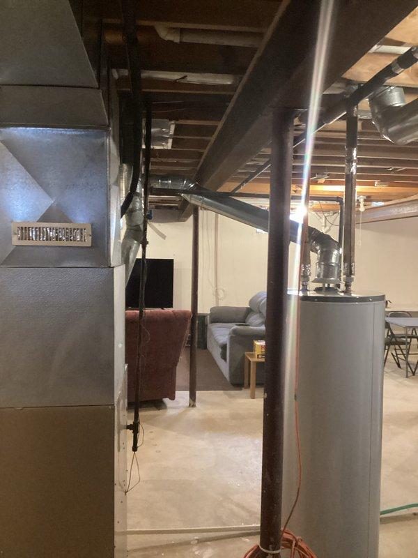 Conducted comprehensive assessment of existing UltraPro furnace system in partially finished basement. Provided detailed replacement estimate (Quote #03817-03 and #03817-02) for furnace replacement, documenting current installation configuration including ductwork connections, drainage system, and proximity to water heater. Photos taken of complete HVAC setup to support accurate estimation for "Furnace est3-4p" proposal.