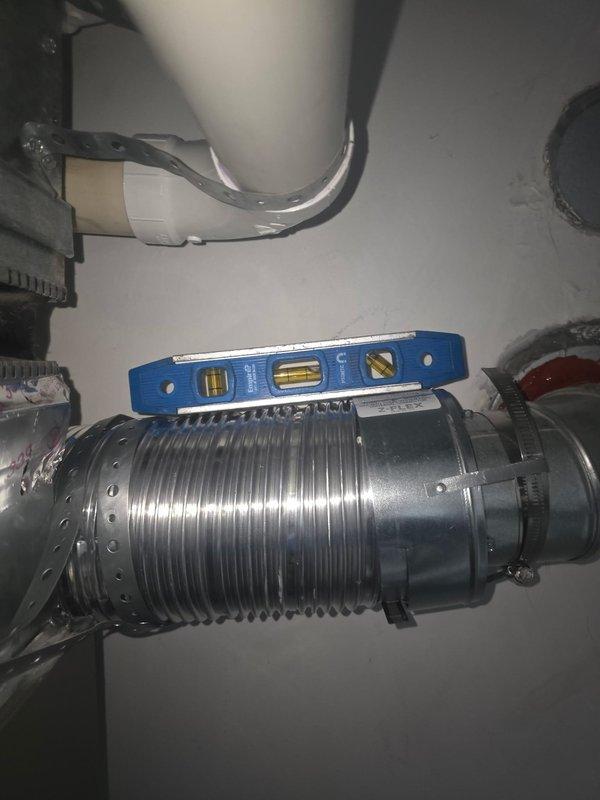 Responded to callback for failed inspection due to negative pitch on water heater vent. Used level to verify improper slope of metal ductwork/ventilation piping. Corrected the installation angle of the Bradford White water heater's flexible metallic vent pipe to ensure proper exhaust flow, bringing the system into compliance with code requirements.