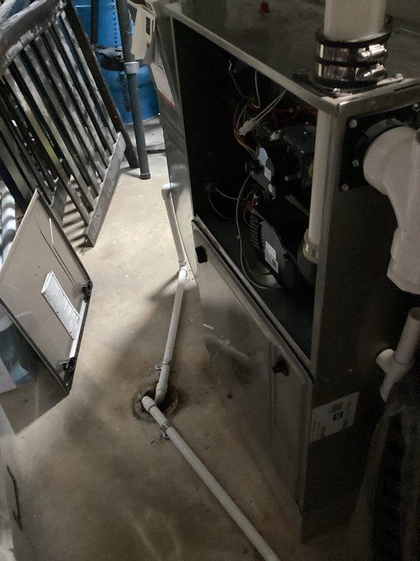 Performed standard maintenance on dual furnace systems located in basement utility areas. Addressed thermostat issue in lower level kitchen area where unit was not properly adhering to wall; cleaned paint splatter from thermostat surface as requested. Both furnace units were inspected with access panels opened to examine internal components, wiring and controls.