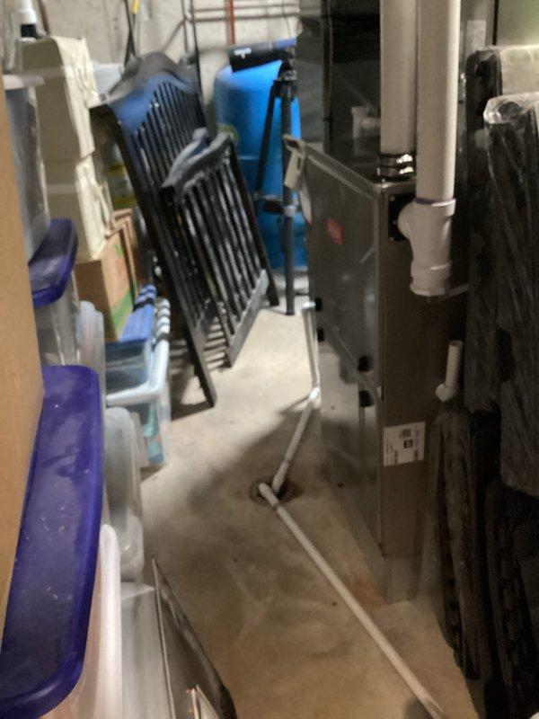 Performed standard maintenance on dual furnace systems located in basement utility areas. Addressed thermostat issue in lower level kitchen area where unit was not properly adhering to wall; cleaned paint splatter from thermostat surface as requested. Both furnace units were inspected with access panels opened to examine internal components, wiring and controls.