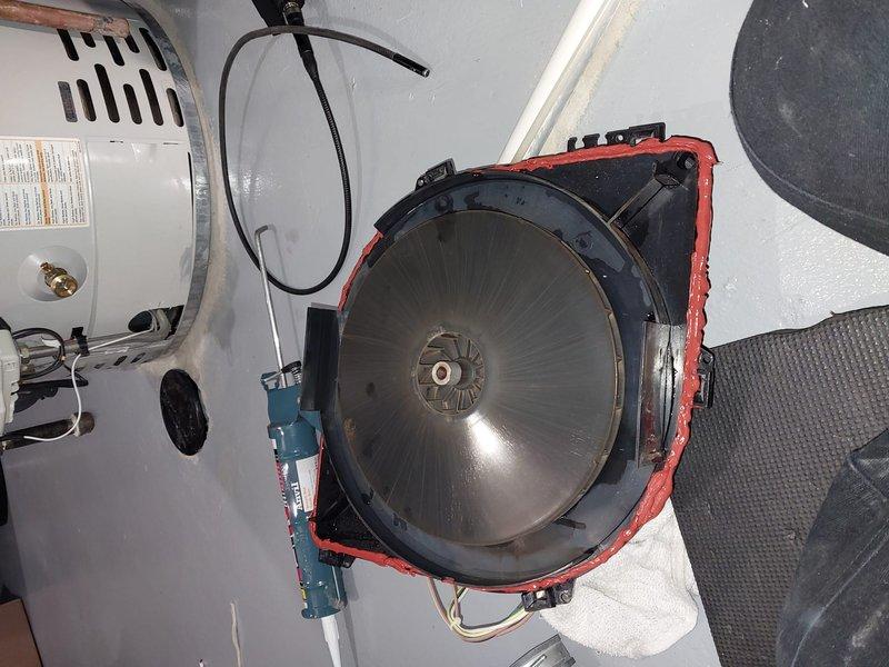 Performed scheduled Worry Free Service Agreement maintenance on heating system during 3-5PM appointment window. Documented significant copper pipe connection deterioration showing advanced corrosion with mineral deposits and rust accumulation. Inspected mechanical unit with circular fan component and adjacent water heater/tank, noting all connections and operational status.