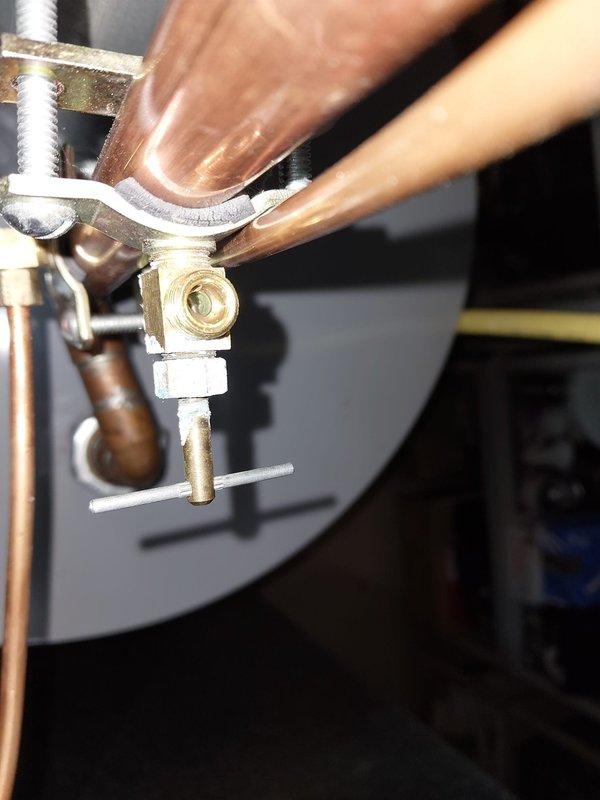 Responded to service call for a 15-year-old furnace producing unusual noise. Conducted comprehensive system inspection, focusing on connection points and humidifier components. Identified and secured loose copper piping connections at brass fitting junction and verified proper operation of the humidifier unit mounted on ductwork, ensuring all electrical connections (red, yellow, blue wiring) were properly secured and functional.