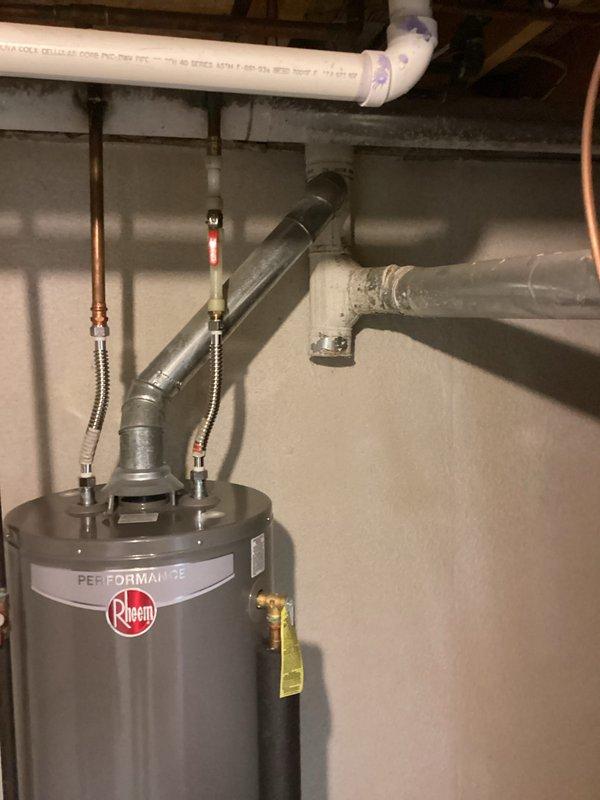 Conducted estimate for replacement of 29-year-old Bryant furnace located in basement. Inspected existing HVAC system including ductwork connections and exhaust flue configuration. Also noted Rheem Performance water heater installation with associated plumbing connections that would need to be considered in the replacement plan. Photos documented current setup for proper sizing and installation requirements of new furnace.