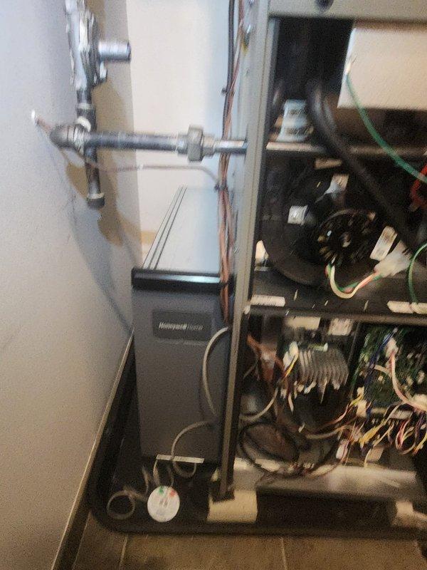 Responded to callback for a Honeywell thermostat installation issue where only 2 of 4 mounting screws were installed, causing instability. Noted customer request to relocate wiring that currently obstructs filter access. Provided estimate for future furnace removal and reinstallation to accommodate planned flooring renovation.