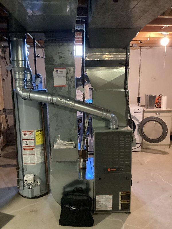 Completed HVAC replacement quote (CQ Quote: 03829-01 FRN Only11A-1P) for residential basement installation. System includes new furnace with PVC condensate drainage, galvanized sheet metal ductwork with proper connections to existing distribution system, and coordination with adjacent water heater placement for optimal mechanical room layout.