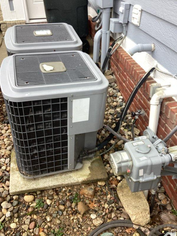 Performed comprehensive replacement of HVAC system, including installation of dual outdoor AC condensers on concrete pads with proper electrical connections and condensate drainage. Interior work included mounting a new Comfortmaker furnace unit in the utility area, completing all necessary ventilation and drainage connections with PVC piping. Documentation of installation was captured for quality assurance purposes.