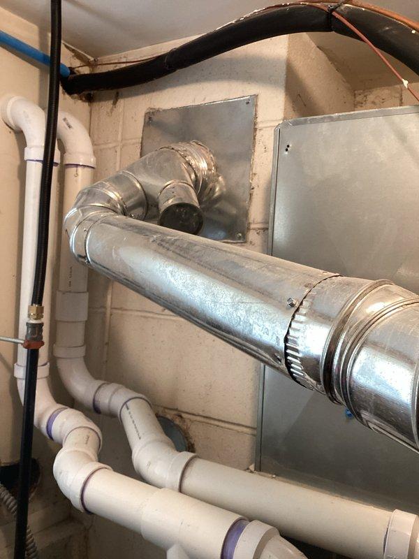 Performed water heater estimate for Lochinvar unit installed approximately 5/25/17. Inspected existing ventilation system including metal ductwork and connections. Noted PVC supply lines with purple primer at joints and evaluated current exhaust configuration for replacement compatibility.