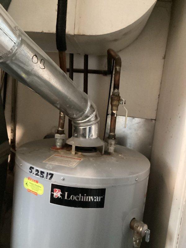 Performed water heater estimate for Lochinvar unit installed approximately 5/25/17. Inspected existing ventilation system including metal ductwork and connections. Noted PVC supply lines with purple primer at joints and evaluated current exhaust configuration for replacement compatibility.