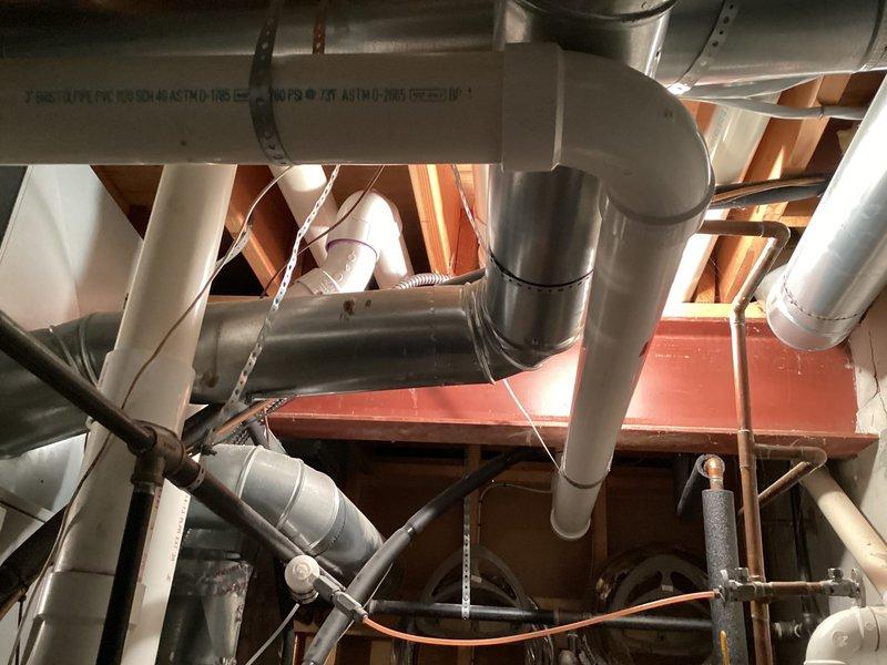 Successfully installed Lennox furnace in basement utility area, including replacement of wrap around return with a 12x24" return. System installation included proper connection of PVC venting, copper lines, and integration with existing ductwork, with all components securely mounted to structural elements.