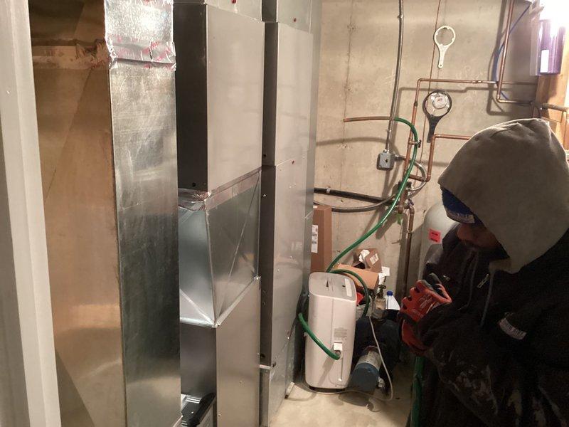 Successfully installed Lennox furnace in basement utility area, including replacement of wrap around return with a 12x24" return. System installation included proper connection of PVC venting, copper lines, and integration with existing ductwork, with all components securely mounted to structural elements.
