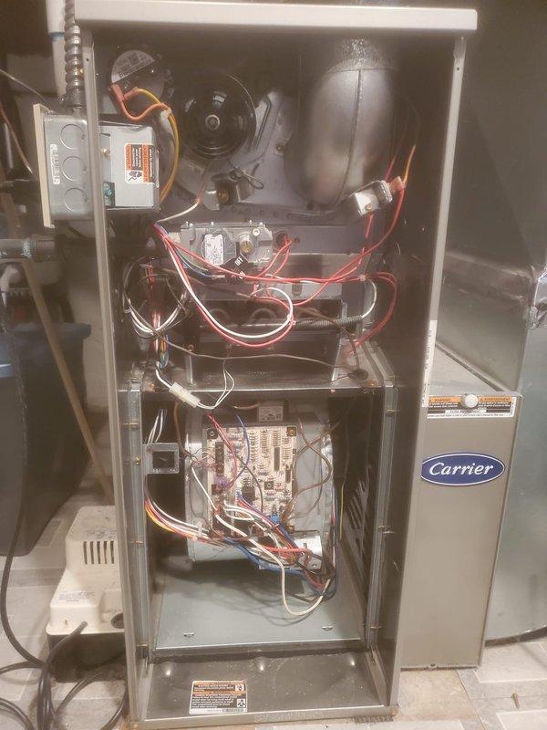 Performed scheduled maintenance on Carrier furnace including full inspection of internal components. Checked blower motor assembly, circuit board connections, and wiring for proper operation. Unit was found to be in normal working condition with no signs of damage or unusual wear.