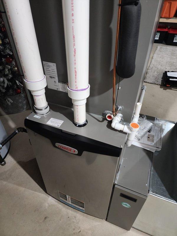 Performed scheduled maintenance on two Lennox furnace systems located in the basement. Inspected all components including PVC intake/exhaust venting, copper refrigerant lines with insulation, condensate drainage system with clean-out access, and verified proper connection to existing ductwork. Both units were confirmed to be in good working condition with no visible damage or required repairs.