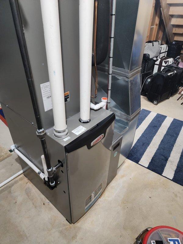 Performed scheduled maintenance on two Lennox furnace systems located in the basement. Inspected all components including PVC intake/exhaust venting, copper refrigerant lines with insulation, condensate drainage system with clean-out access, and verified proper connection to existing ductwork. Both units were confirmed to be in good working condition with no visible damage or required repairs.