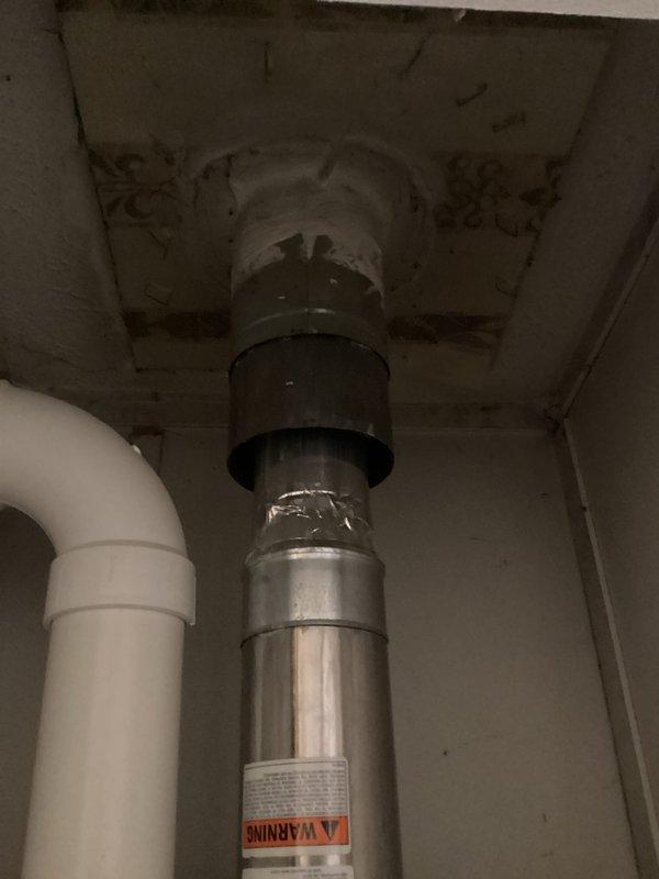 Conducted comprehensive inspection of existing tankless water heater system, documenting deteriorated exhaust venting and aging control panel components. Evaluation revealed need for replacement due to inefficient operation and potential safety concerns with the current installation. Photos taken of internal components and ventilation configuration to support replacement recommendation.