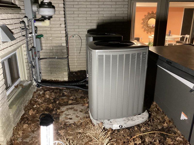 Completed installation of a full double HVAC system including outdoor condenser unit on concrete pad and indoor furnace with PVC venting in utility area. System includes proper condensate drainage, electrical connections, and all necessary ductwork for complete functionality. All components were tested and verified operational upon completion.