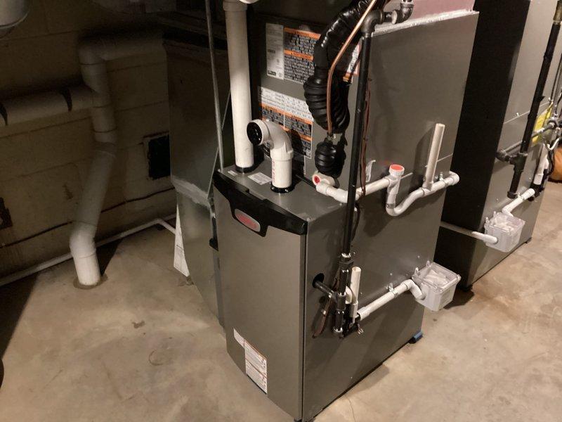 Completed installation of a full double HVAC system including outdoor condenser unit on concrete pad and indoor furnace with PVC venting in utility area. System includes proper condensate drainage, electrical connections, and all necessary ductwork for complete functionality. All components were tested and verified operational upon completion.