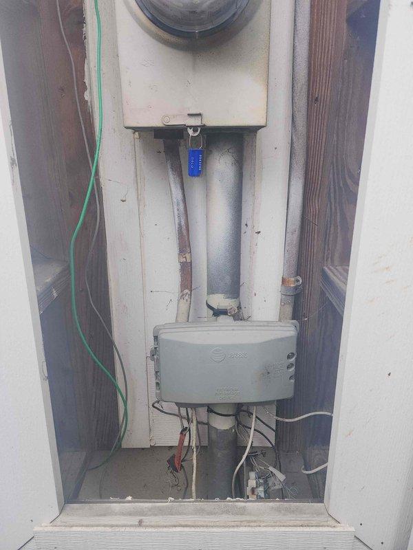 Conducted an on-site assessment for electrical panel upgrade. Inspected existing recessed utility installation with aging components, including meter housing and junction box with multiple wire connections. Documented current configuration of dual-meter setup in exterior wall enclosure for proper upgrade planning.