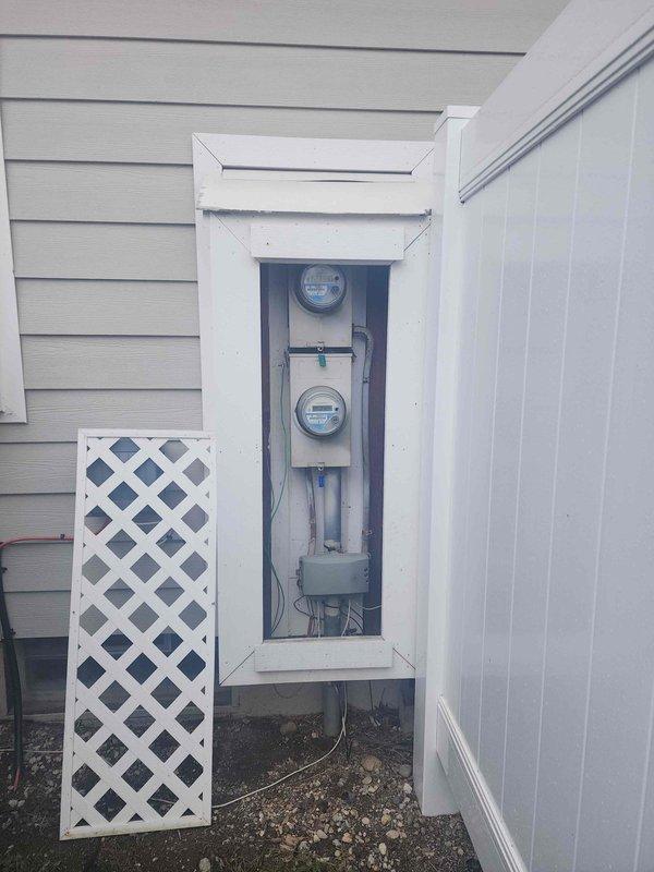 Conducted an on-site assessment for electrical panel upgrade. Inspected existing recessed utility installation with aging components, including meter housing and junction box with multiple wire connections. Documented current configuration of dual-meter setup in exterior wall enclosure for proper upgrade planning.