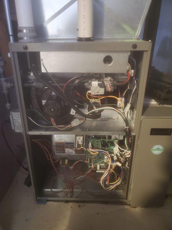 Performed scheduled prepaid maintenance on Lennox HVAC system. Opened access panel to inspect internal components including circuit boards, wiring connections, blower motor assembly, and gas valve mechanism. All systems verified operational with proper ventilation through PVC exhaust pipes; no issues detected during this routine maintenance visit.