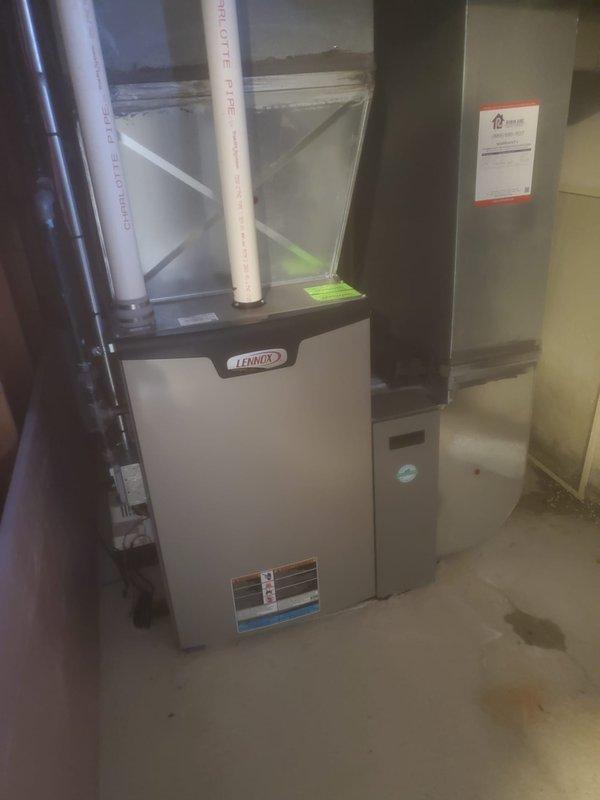 Performed scheduled prepaid maintenance on Lennox HVAC system. Opened access panel to inspect internal components including circuit boards, wiring connections, blower motor assembly, and gas valve mechanism. All systems verified operational with proper ventilation through PVC exhaust pipes; no issues detected during this routine maintenance visit.