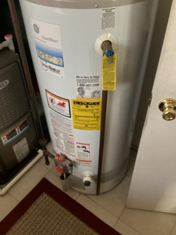 Completed inspection of existing 40-gallon GE SmartWater water heater (CQ Quote: 03847-01) to provide replacement estimate. Unit appears operational with proper inlet/outlet connections and vent piping intact, but approaching end of service life. Documented current installation configuration including copper supply lines, TPR valve, and flue venting system to ensure accurate quote for compatible replacement.