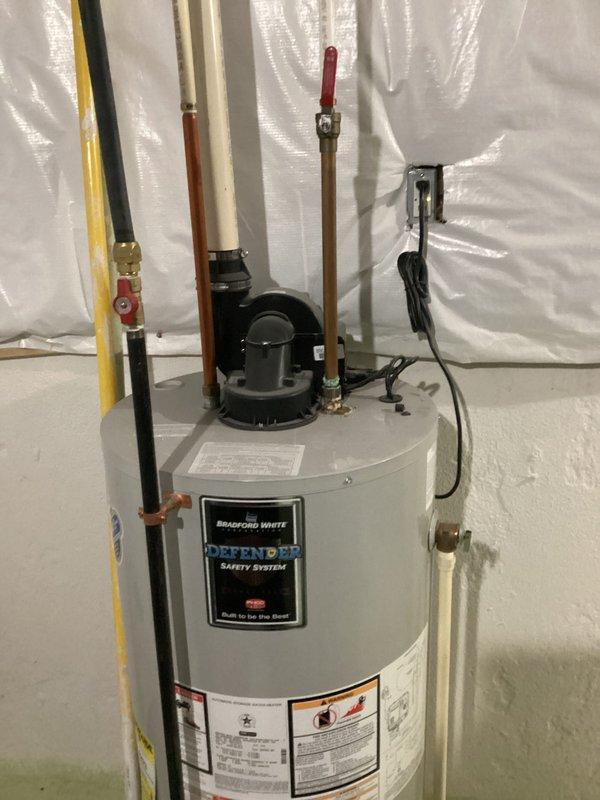 Successfully installed a new Bradford White water heater with Defender Safety System in the basement utility area between 11AM-1PM. Completed all necessary copper and PVC pipe connections, installed proper valves, and ensured proper ventilation system functionality. Final inspection confirmed all plumbing components are securely fitted with no leaks present.