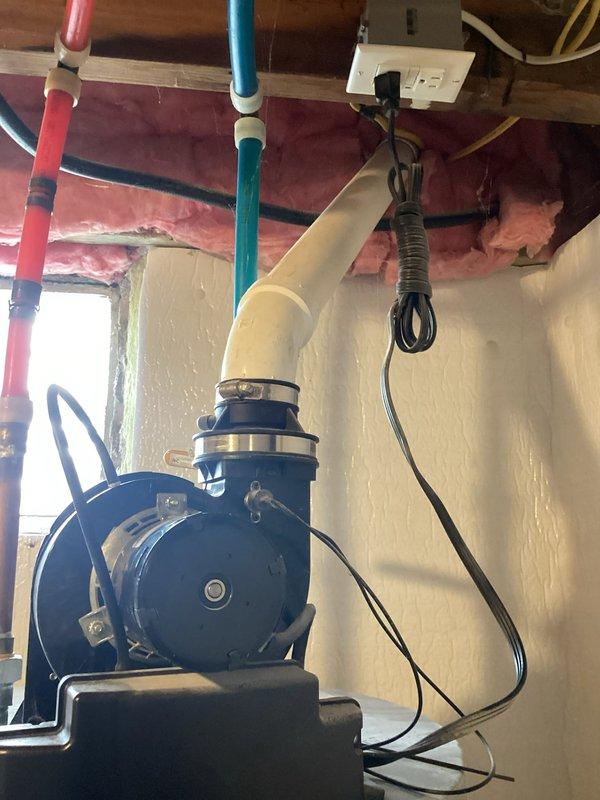 Conducted assessment of 10-year-old water heater with active leak. Unit shows signs of deterioration at connections, with water accumulation at base. System includes standard hot/cold water lines with expansion tank mounted adjacent to unit. Recommended full replacement due to age and failure of tank integrity.