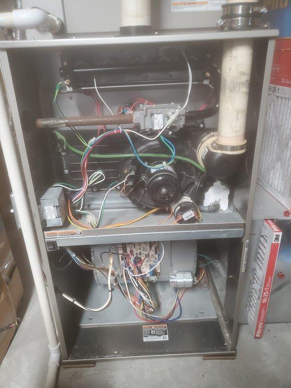 Performed annual maintenance on Bryant two-stage furnace system (model 10-12). Removed access panels to inspect blower motor assembly, electronic control boards, and gas valve assembly with copper gas line. Verified proper operation of all electrical components including wiring connections and relays. Confirmed proper installation and functionality of PVC intake/exhaust venting system. Unit is operating within manufacturer specifications.