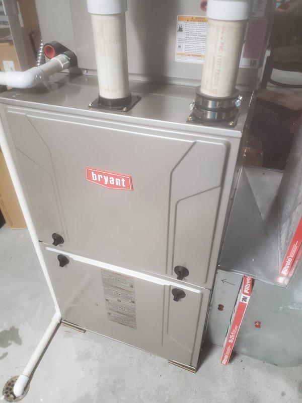 Performed annual maintenance on Bryant two-stage furnace system (model 10-12). Removed access panels to inspect blower motor assembly, electronic control boards, and gas valve assembly with copper gas line. Verified proper operation of all electrical components including wiring connections and relays. Confirmed proper installation and functionality of PVC intake/exhaust venting system. Unit is operating within manufacturer specifications.