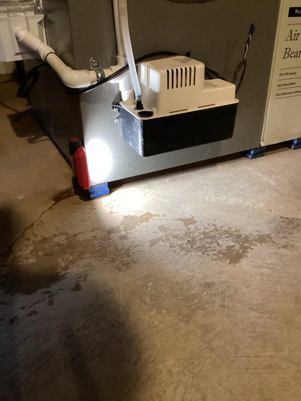 Responded to warranty service call for water leak beneath Trane furnace. Discovered condensate pump malfunction causing water to pool on concrete floor. Replaced defective pump under parts and labor warranty coverage.