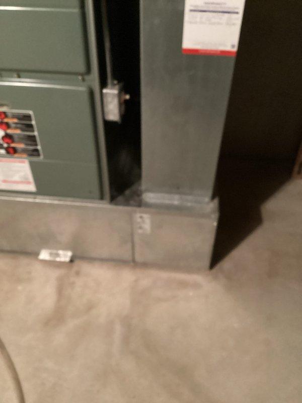 Conducted a replacement estimate for a residential furnace system located in basement utility area. Evaluated existing installation which includes green-gray furnace unit, extensive ductwork, black insulated ducting, and PVC condensate drainage system. Documented current system configuration and structural mounting to provide accurate replacement options.