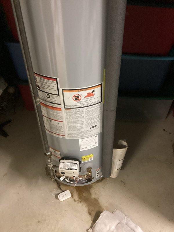 Conducted inspection of State brand water heater exhibiting leakage from tank bottom. Unit shows signs of deterioration with visible water accumulation at base. Documented current installation configuration including gas connections, vent piping, and water supply lines to provide comprehensive replacement estimate as requested.