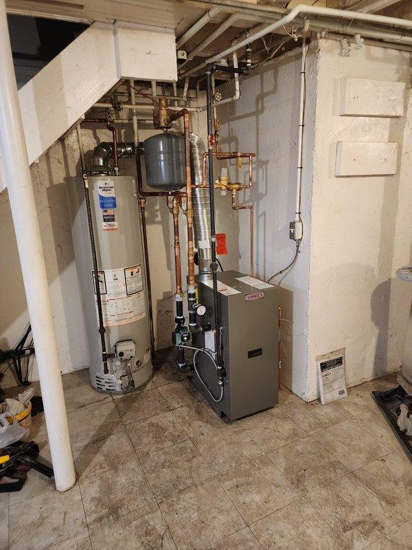 Successfully installed new boiler system with T6 thermostat and chimney liner. System includes Lennox furnace unit connected to water heater with proper copper piping and expansion tank. Verified digital control module functionality with all connections properly secured and system operational.