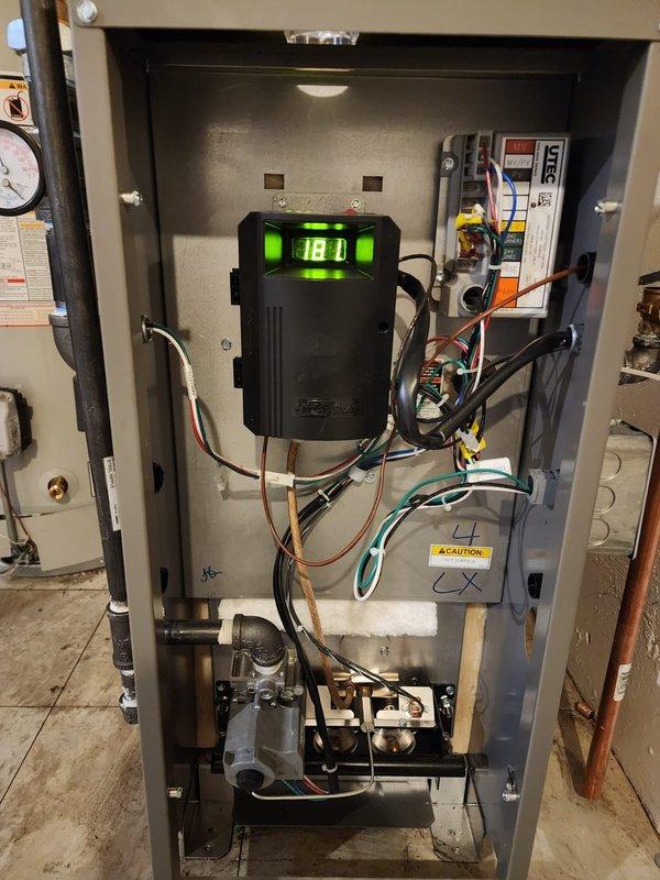 Successfully installed new boiler system with T6 thermostat and chimney liner. System includes Lennox furnace unit connected to water heater with proper copper piping and expansion tank. Verified digital control module functionality with all connections properly secured and system operational.