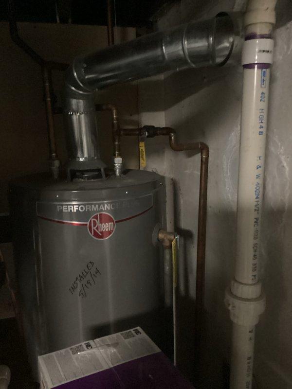 Performed inspection of 35-year-old outdoor air conditioning system on east side of residence. Documented existing Bryant furnace system with PVC venting configuration and associated ductwork in utility area. Also photographed Rheem Performance water heater with copper piping and metal ventilation. Provided replacement estimate for complete AC system upgrade.