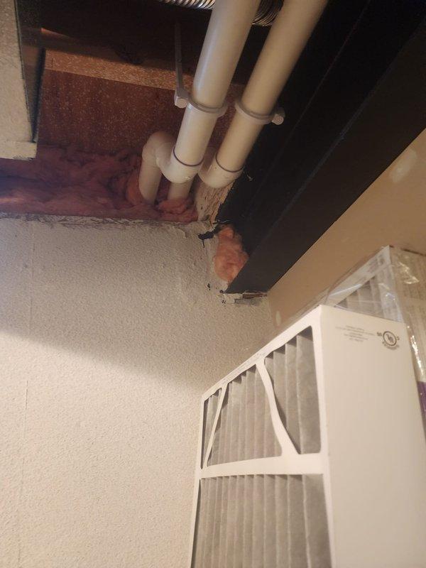 Conducted IAQ assessment at residential property with focus on Lennox 8-12 unit. Inspected exterior ventilation components and documented condition of air filtration system. Identified damaged insulation and exposed PVC plumbing infrastructure in mechanical area requiring attention.