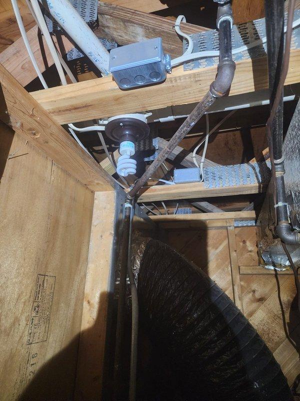 Responded to callback regarding increased noise concerns after previous repair. Inspected attic/crawlspace mechanical infrastructure, including ductwork, electrical components, and mounting hardware. Identified loose CFL fixture near fan assembly as source of vibration noise; secured fixture and verified normal system operation with significantly reduced noise levels.