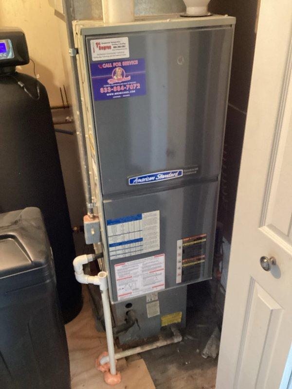 Conducted comprehensive evaluation of existing HVAC system, including aged exterior condenser unit showing significant weathering and an American Standard furnace in the utility closet. Prepared replacement estimate (Quote #03869-02) for complete system upgrade, documenting current installation configuration with supporting photographic evidence for accurate equipment sizing and installation requirements.