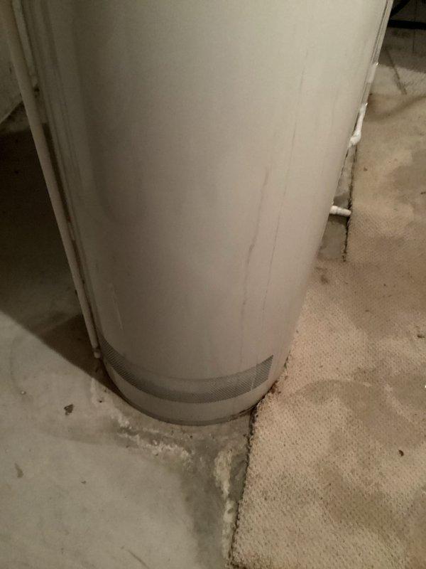 # HVAC Estimate - Replacement Summary

Responded to service call for leaking water heater tank. Upon inspection, confirmed active leak at base of unit with visible mineral deposits and moisture accumulation on concrete floor surrounding tank foundation. Documented existing water heater installation including all plumbing connections, copper supply lines, and venting configuration. Photographed compromised tank showing crystalline buildup indicative of prolonged seepage and tank failure. Prepared comprehensive replacement estimate for new water heater installation to address failed unit and restore domestic hot water service.