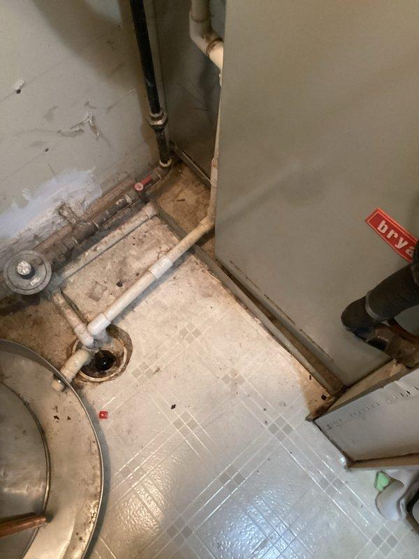 # HVAC Estimate - Replacement Summary

Conducted comprehensive site assessment for furnace and HVAC system replacement at residential property. Evaluated existing utility room configuration including aged water heater, deteriorating plumbing infrastructure, and current heating system setup. Documented existing conditions showing multiple pipe runs (PVC and copper), floor drain access points, and available clearances for equipment installation. Assessed wall conditions, utility connections, and spatial constraints to determine optimal equipment placement and required modifications for new furnace installation. Provided detailed replacement estimate covering equipment specifications, installation requirements, and necessary upgrades to meet current code standards for safe and efficient operation.