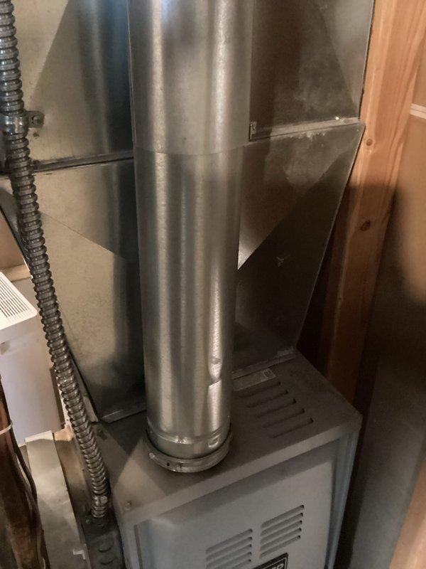 Completed comprehensive estimate for full HVAC system replacement at residential property where existing air conditioning unit has exceeded its service life, showing significant rust and deterioration despite operating through previous cooling season. Assessed both indoor furnace installation in basement utility area and outdoor condensing unit positioned against home exterior, documented current system configuration including ductwork and condensate management components, and provided replacement options for aging equipment to ensure reliable climate control performance.